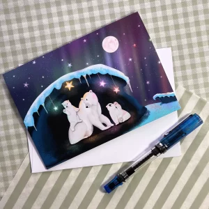 Polar bear greeting card featuring a mama polar bear and cubs in a glowing ice cave under the northern lights by Tracy Serafini