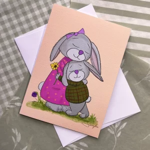 Bunny greeting card featuring a mama bunny hugging her little boy in a green plaid vest by Tom Serafini
